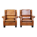 Set of 2 very comfortable large sheepskin armchairs elegantly finished with black piping