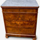 Antique Louis Philippe style chest of drawers with a white marble top.