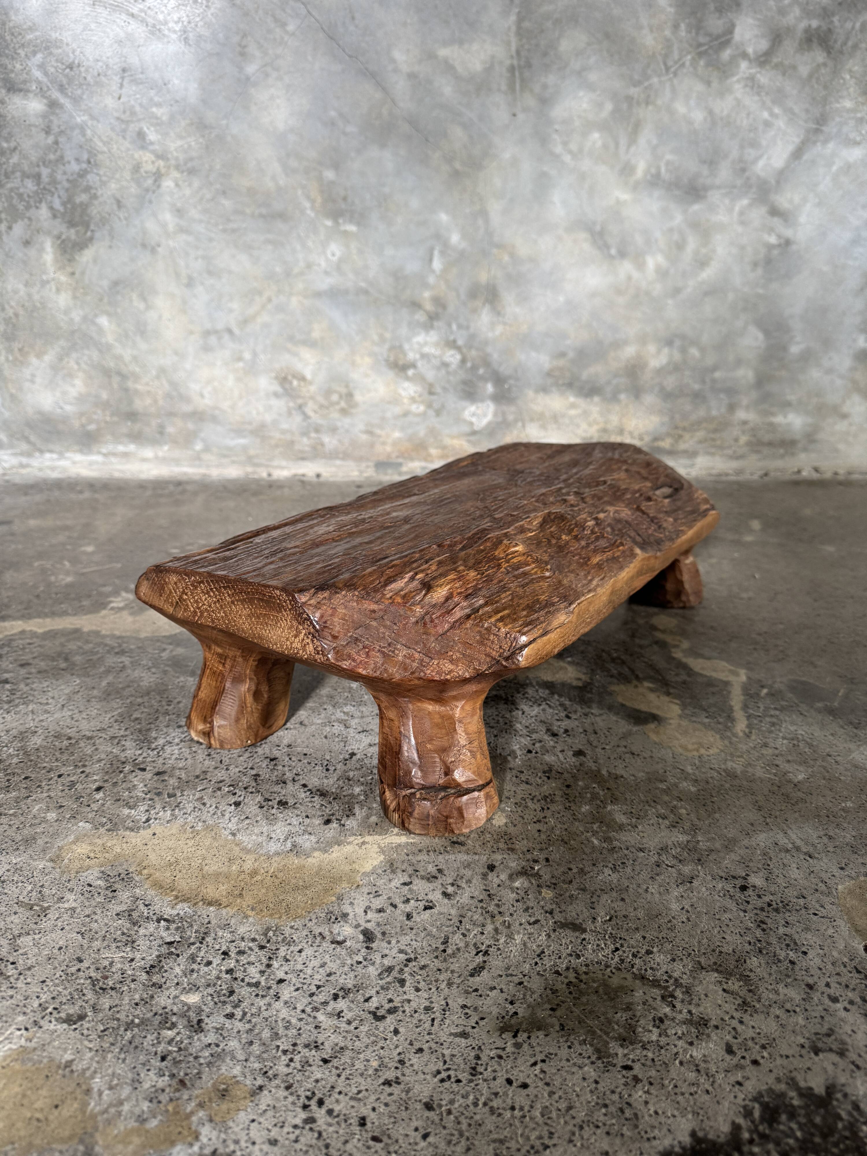 Small stool, footrest in blond teak, organic monoxyle with cut corners.