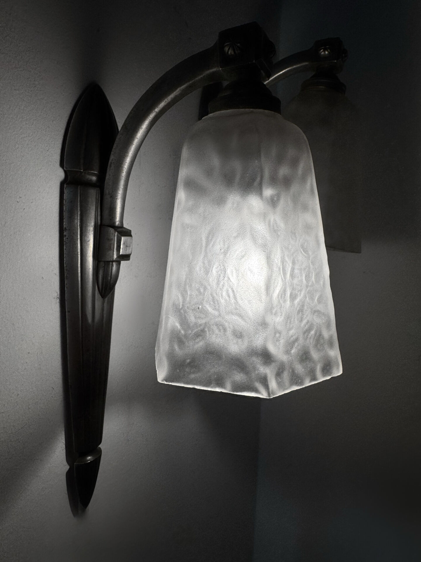 Silver Art Deco wall lights with frosted glass.