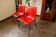 Pair of red plastic chairs with metal frame