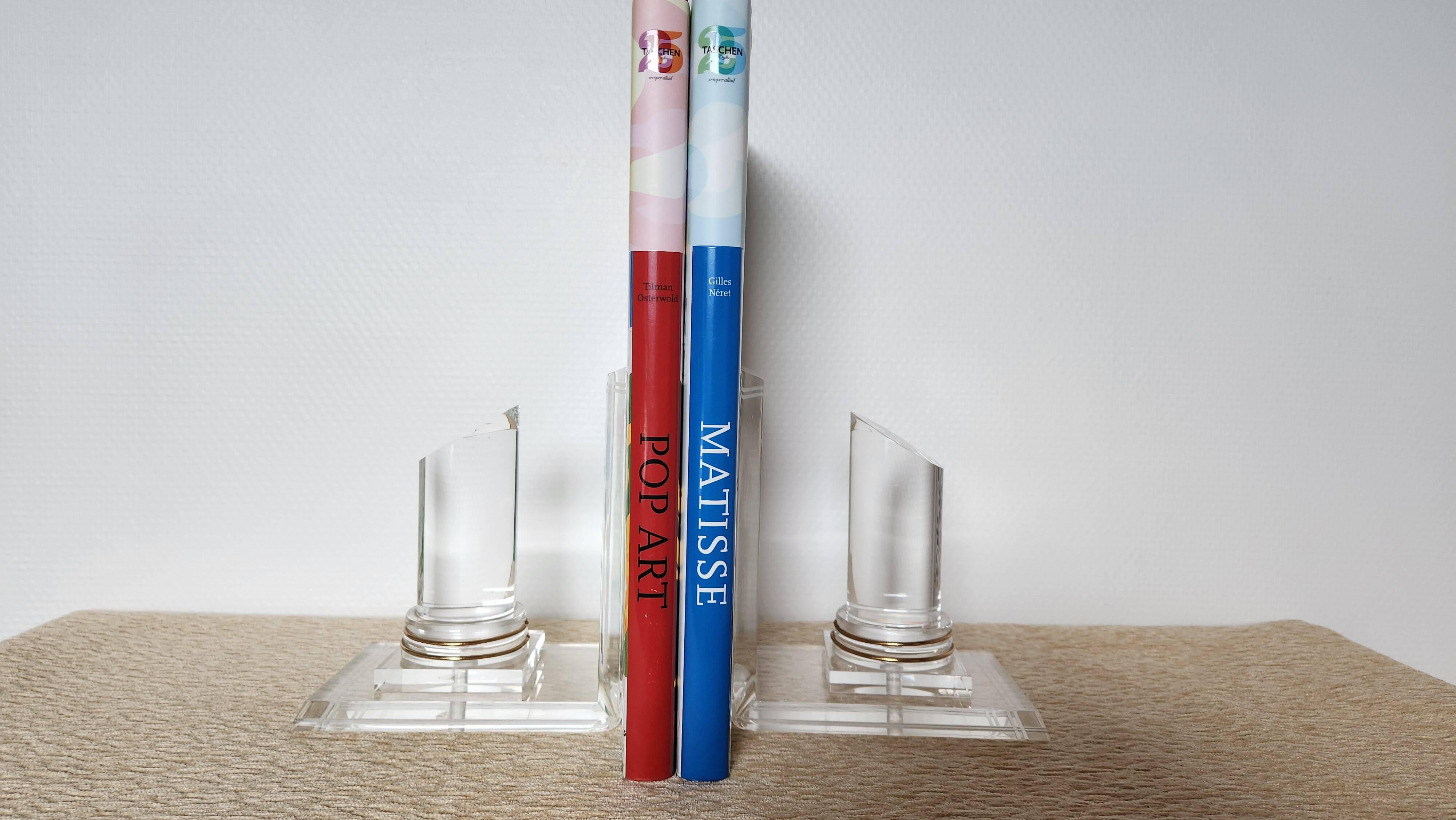 Pair of column bookends in plexiglass and gold metal, 1980s design.