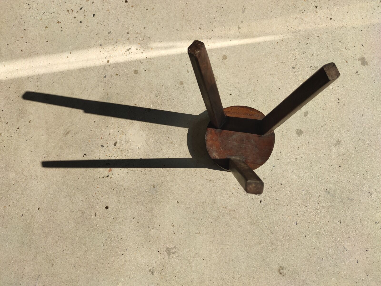 Small high tripod stool in brown solid wood