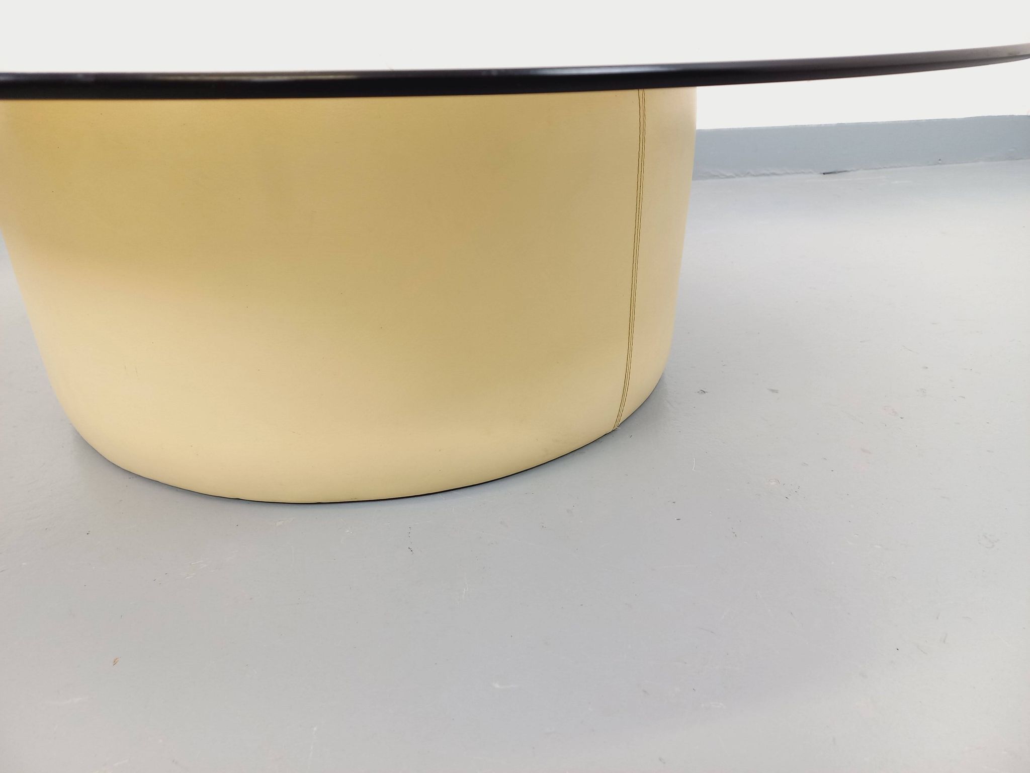 Vintage round coffee table in glass, leather, and metal in Space Age style from the 70s.