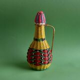 Glass bottle covered with multicolored scoubidou