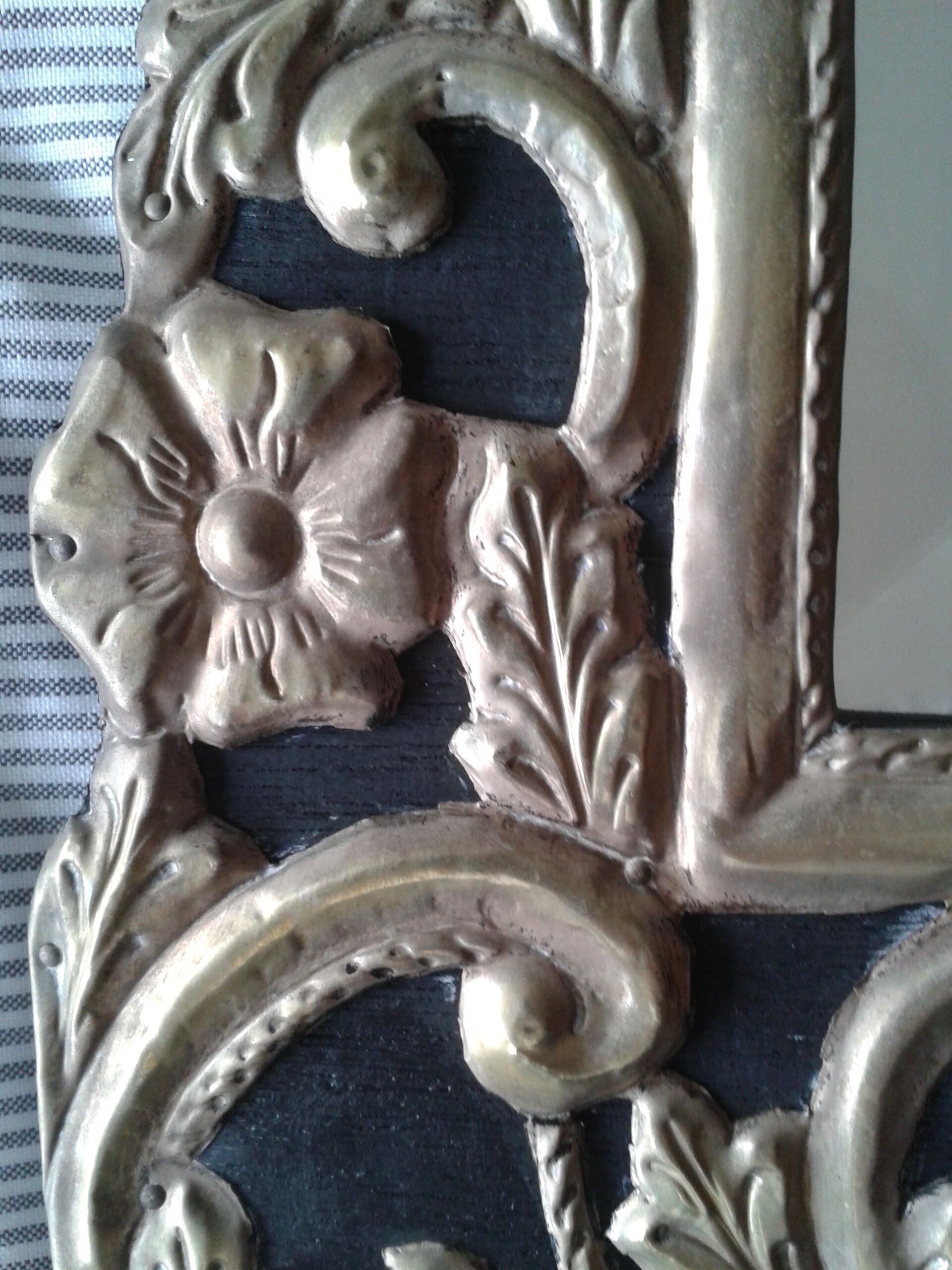 Mirror with embossed metal décor