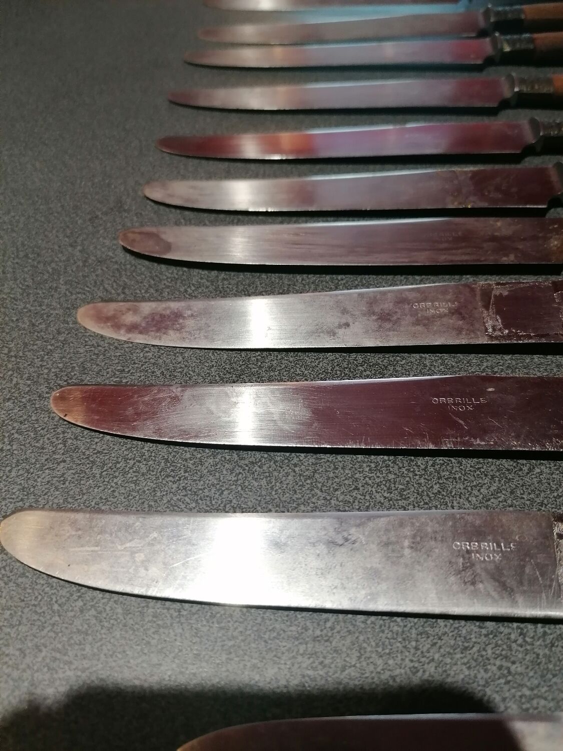 Old table knives and dessert knives, wooden handles, stainless steel blades