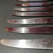 Old table knives and dessert knives, wooden handles, stainless steel blades