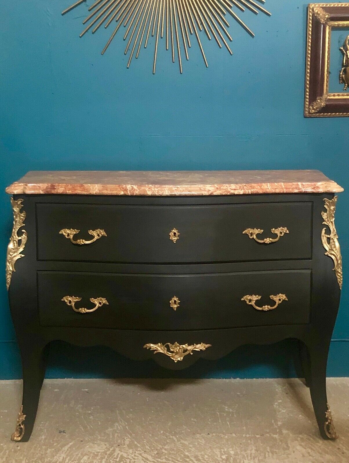 Louis XV style curved black matte commode with gilded bronze ornamentation from the 1950s.
