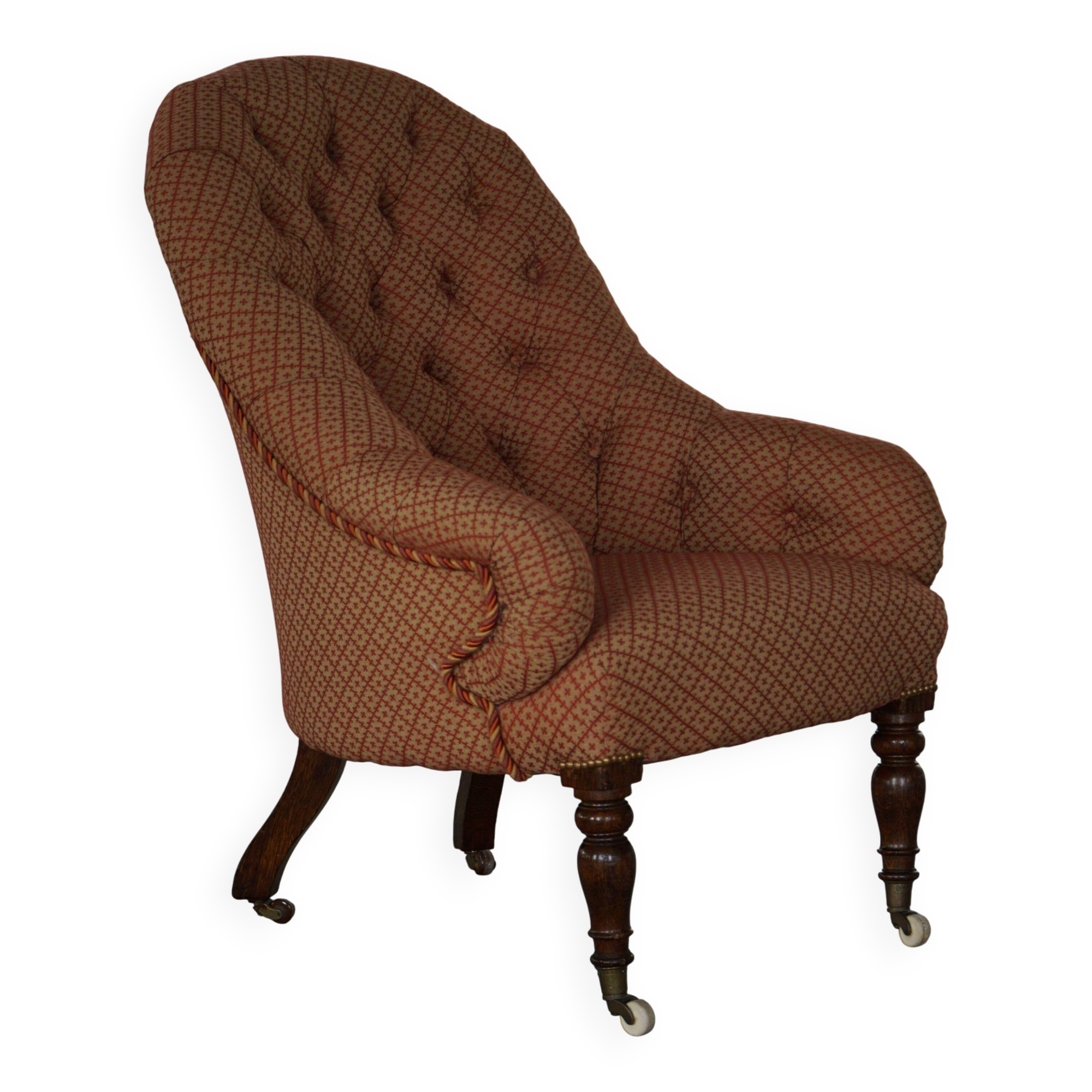 Victorian mahogany armchair, with wheels and coloured fabric, England, early 1900s.