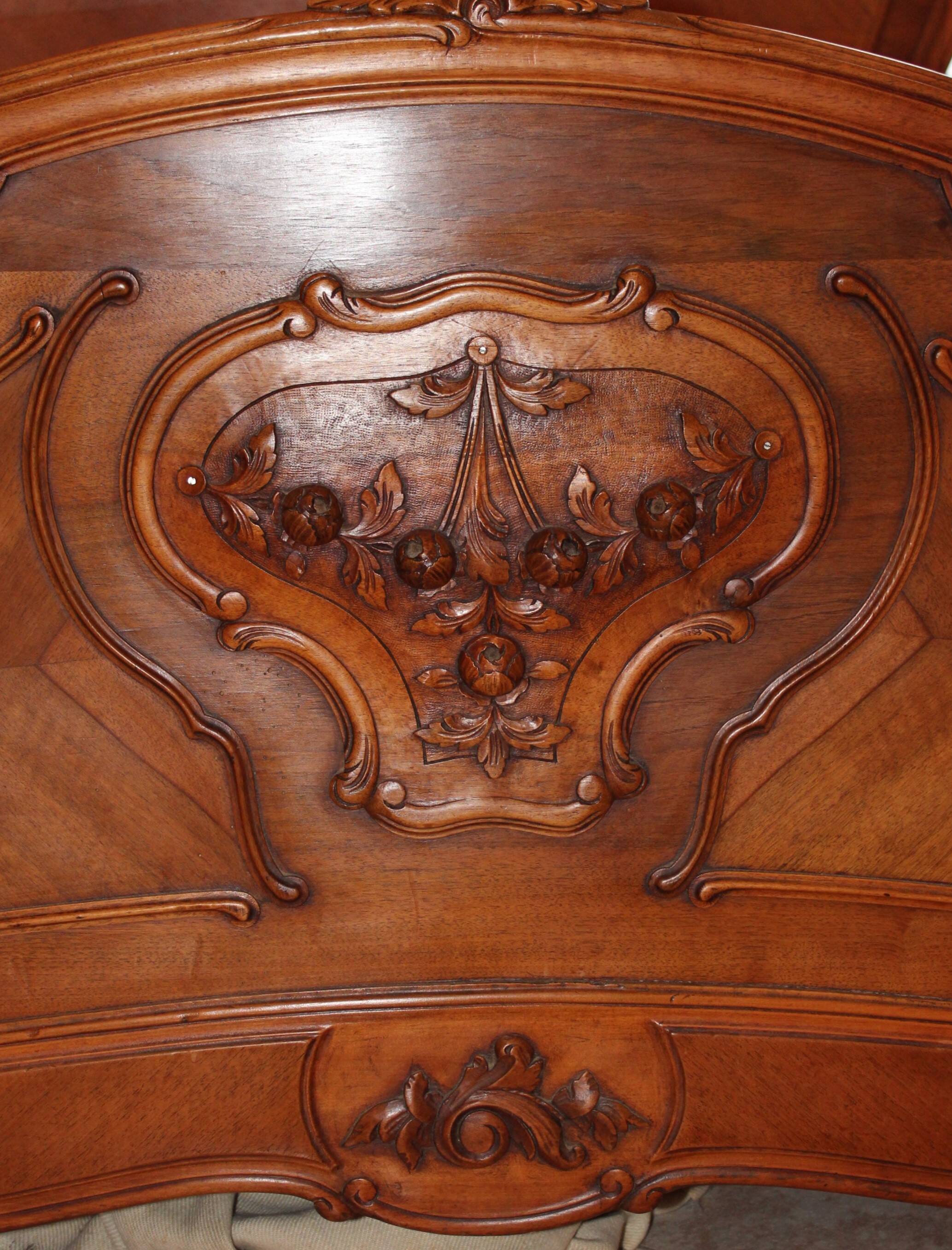 Walnut rocaille bed from the early 20th century.