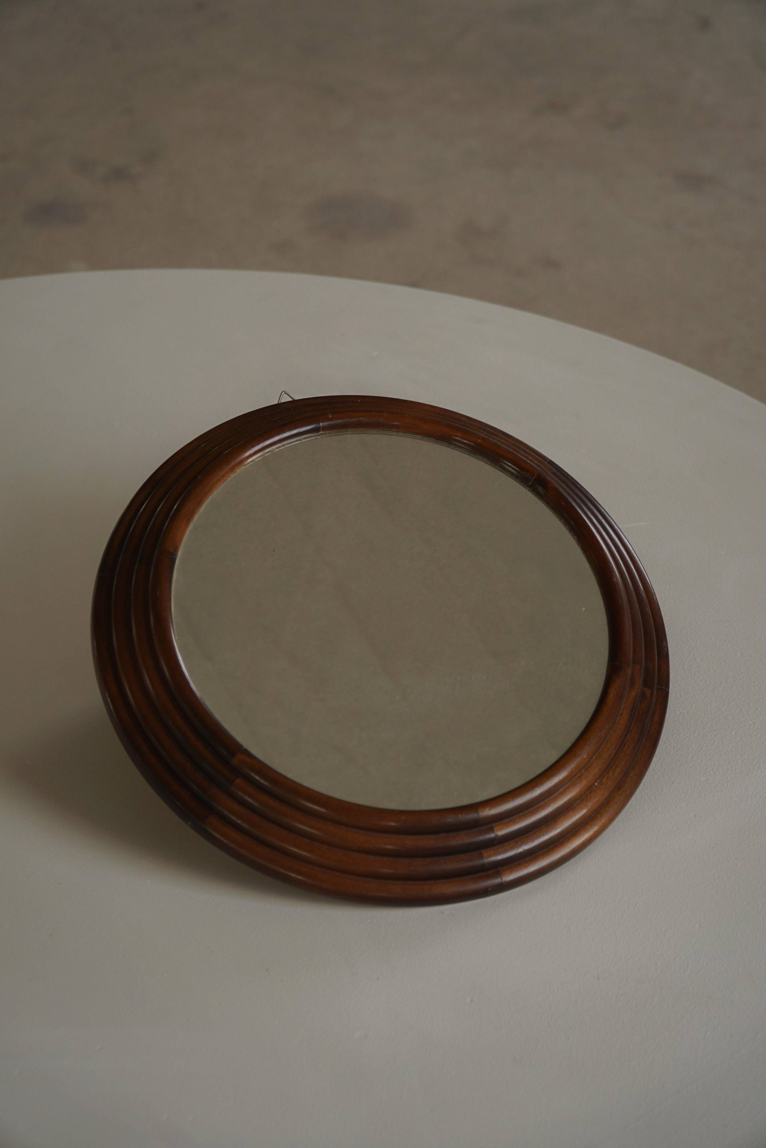 Round wooden wall decorative mirror, carved frame, mid-20th century, 1950s.