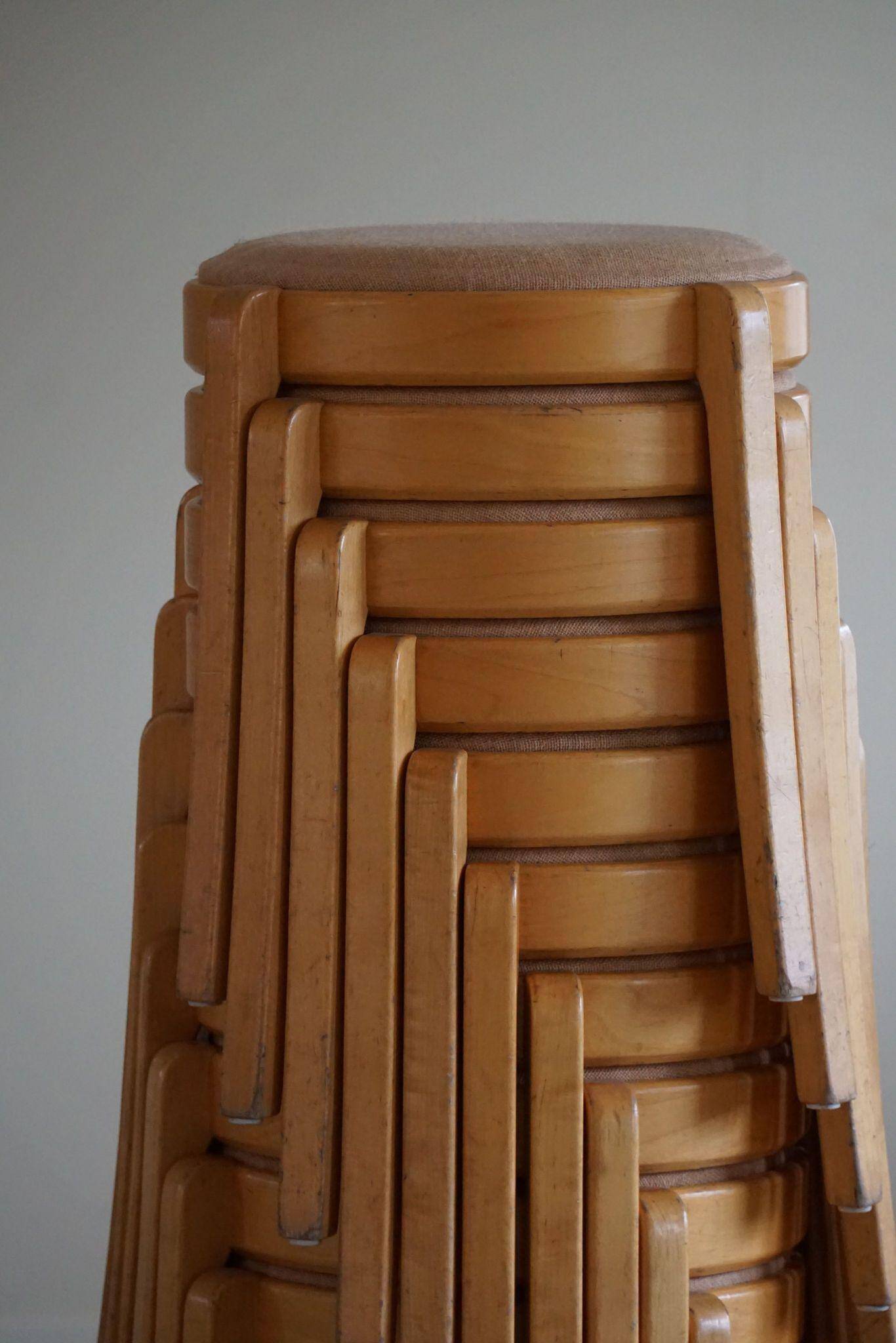 Set of 14 modern Swedish stackable stools in birch and hessian, 1980s.