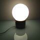 Lampe globe en opaline blanche sur socle bois