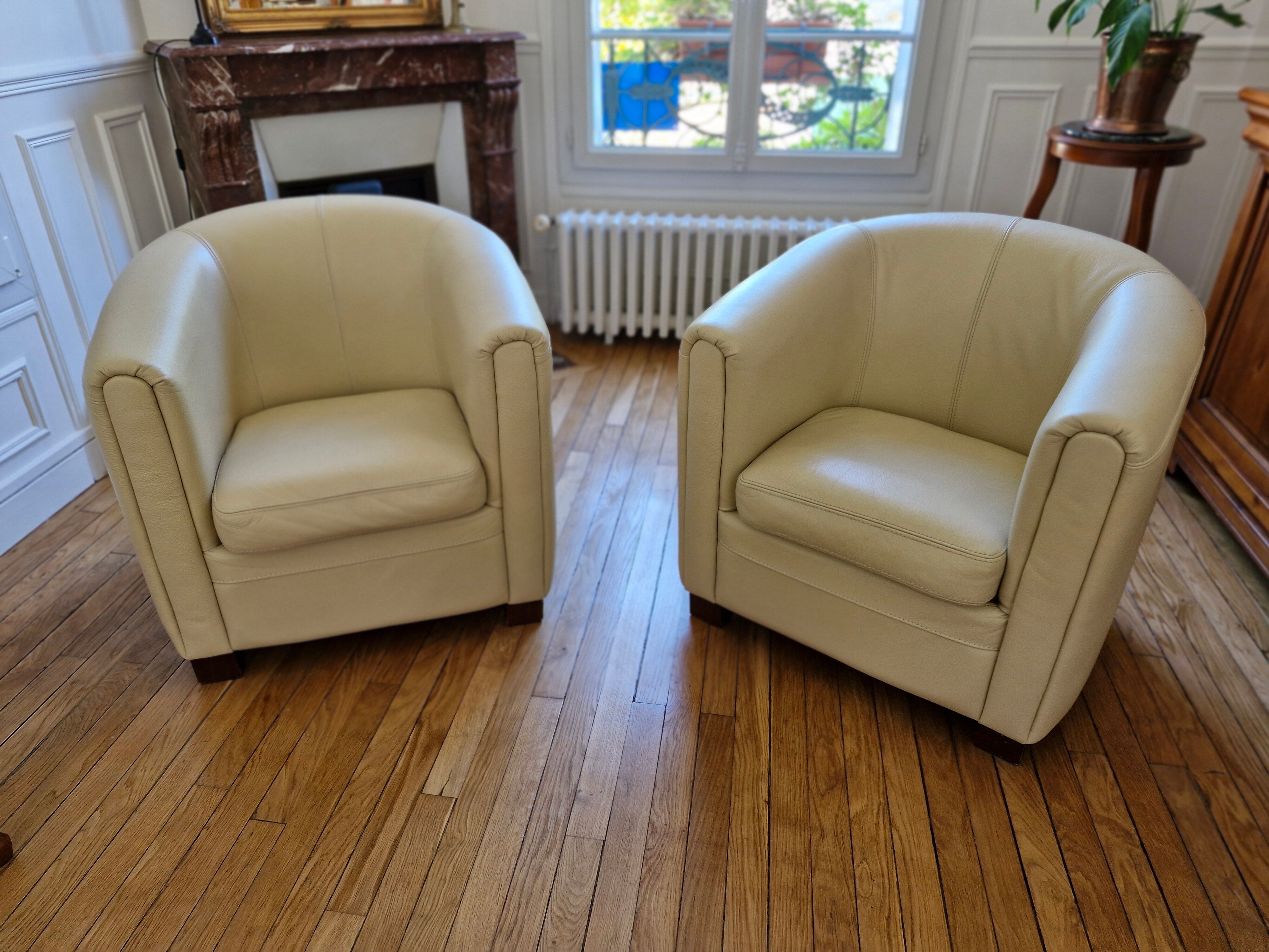 A pair of genuine leather club armchairs.