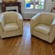 A pair of genuine leather club armchairs.