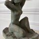 Sculpture of a naked woman titled "Youth" in terracotta.