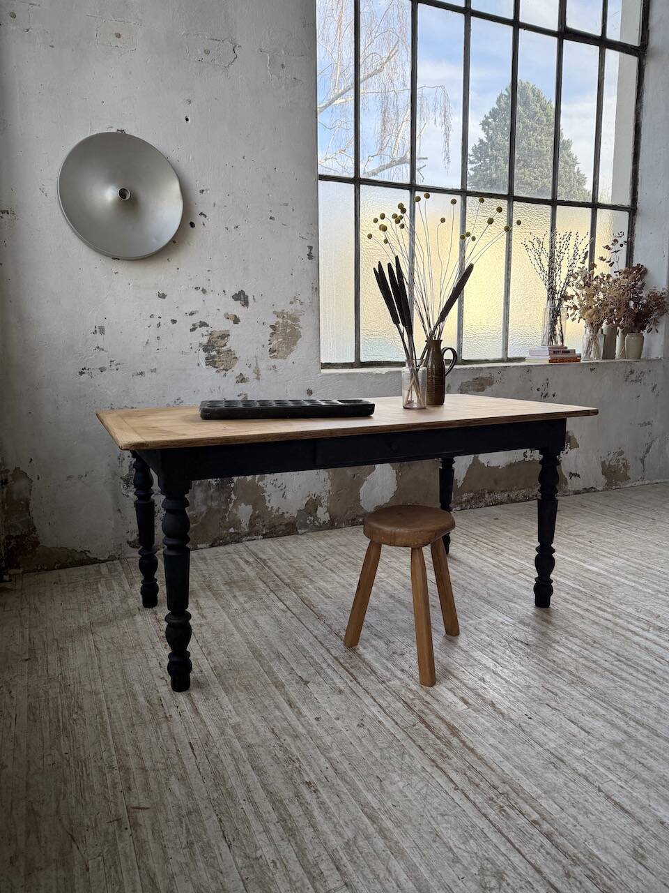 Oak farmhouse table with turned black legs.