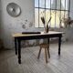 Oak farmhouse table with turned black legs.