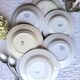 Antique mismatched earthenware soup plates with a tureen