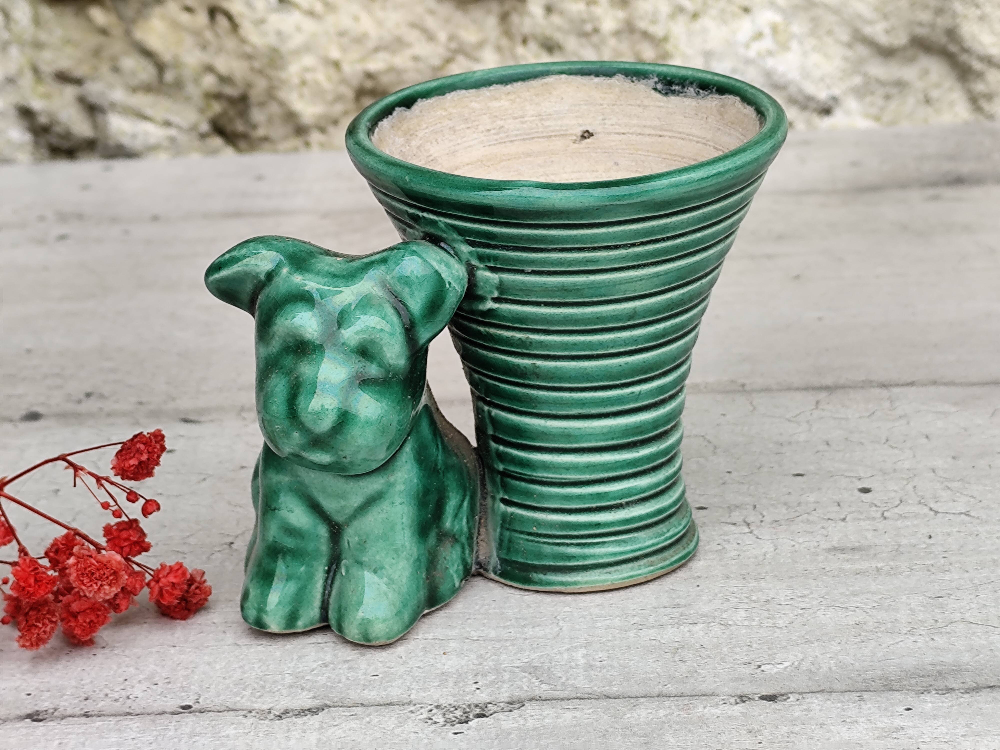 Green ceramic empty pocket dog statue