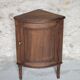Antique wooden corner cabinet with a curved door.