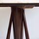 Mid-century modern round dining table in marble and ebony wood.