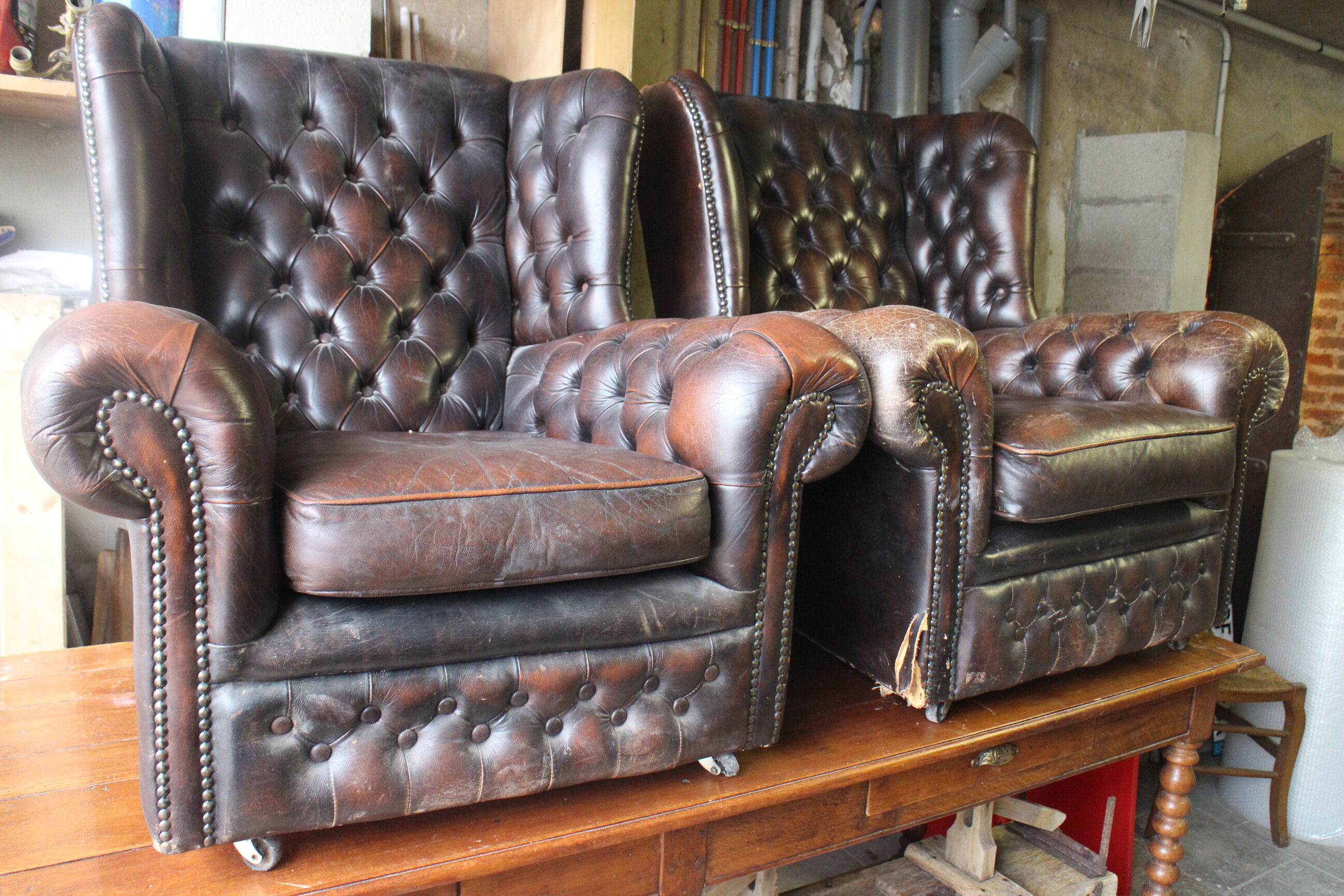 Padded chesterfield leather armchairs