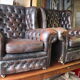 Padded chesterfield leather armchairs