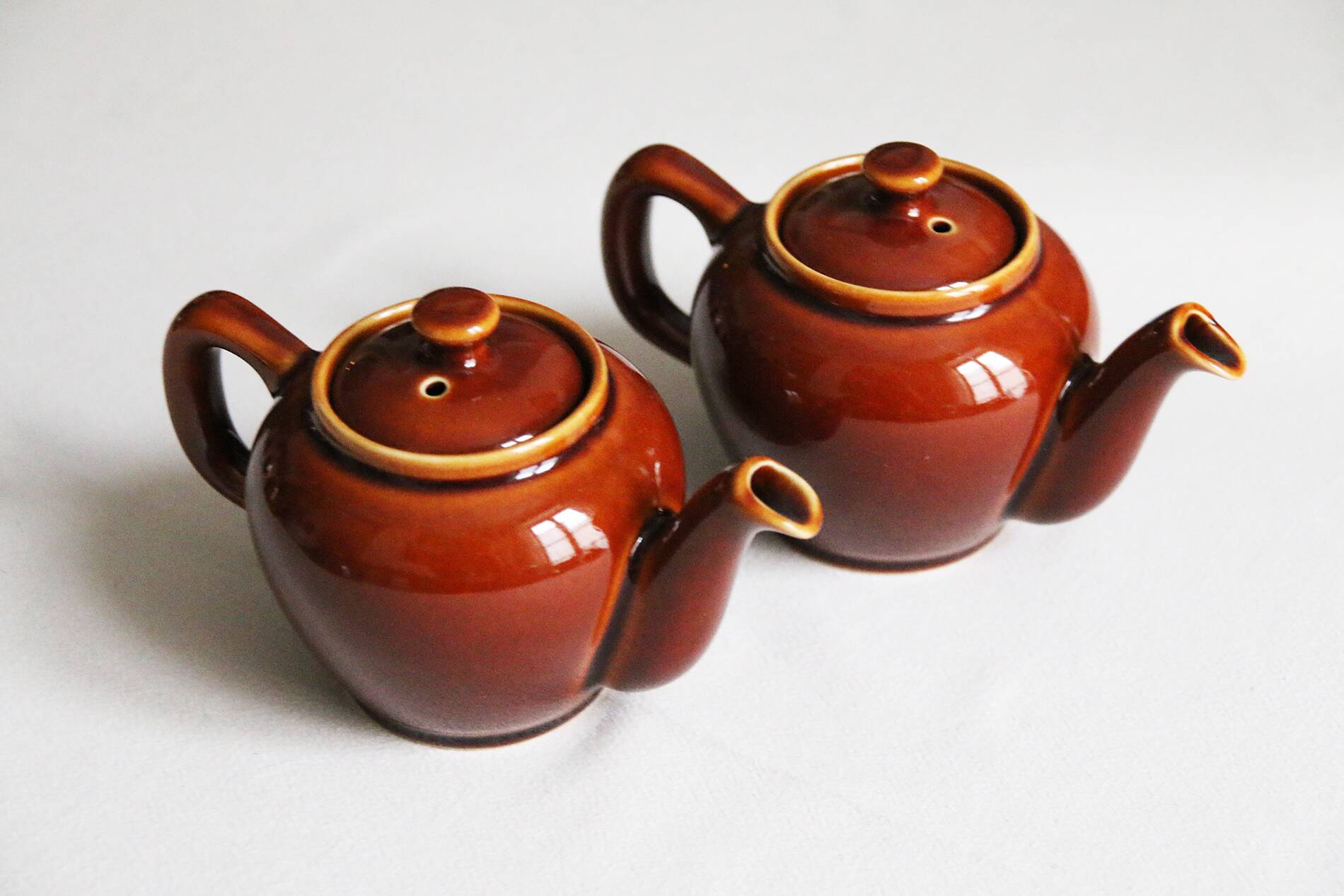 2 brown glazed ceramic teapots