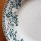 Assiette en faïence ancienne à décor de couronne de fleurs