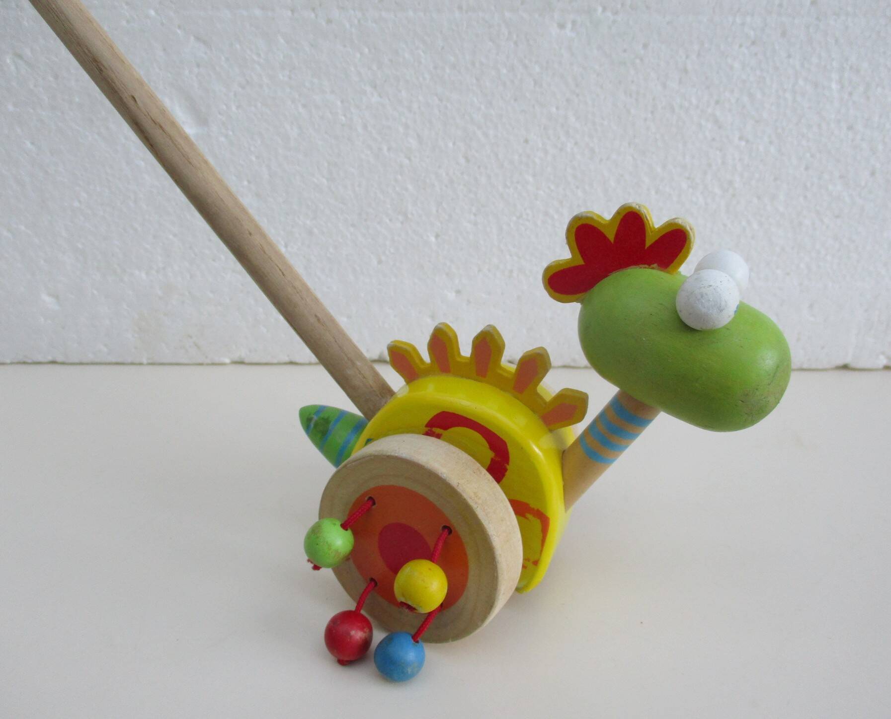 Push toy, wooden dinosaur. Brand: Bino
