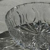 Circular glass ashtray with stylized petal patterns