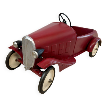 Vintage red tin pedal car for children – 1930s
