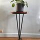 Vintage tripod harness round wooden top on black lacquered metal stand