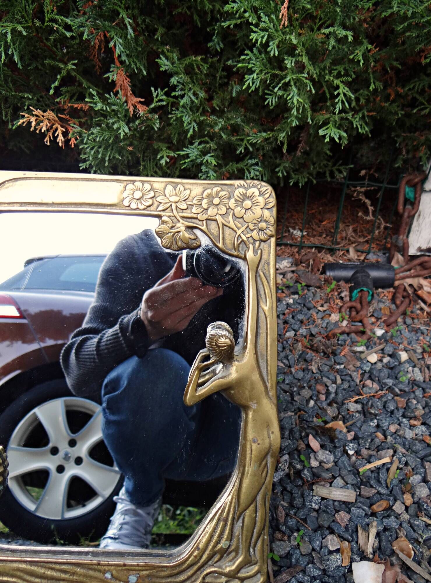 Art Nouveau mirror in gilded brass with a woman figure emerging from a vintage frame