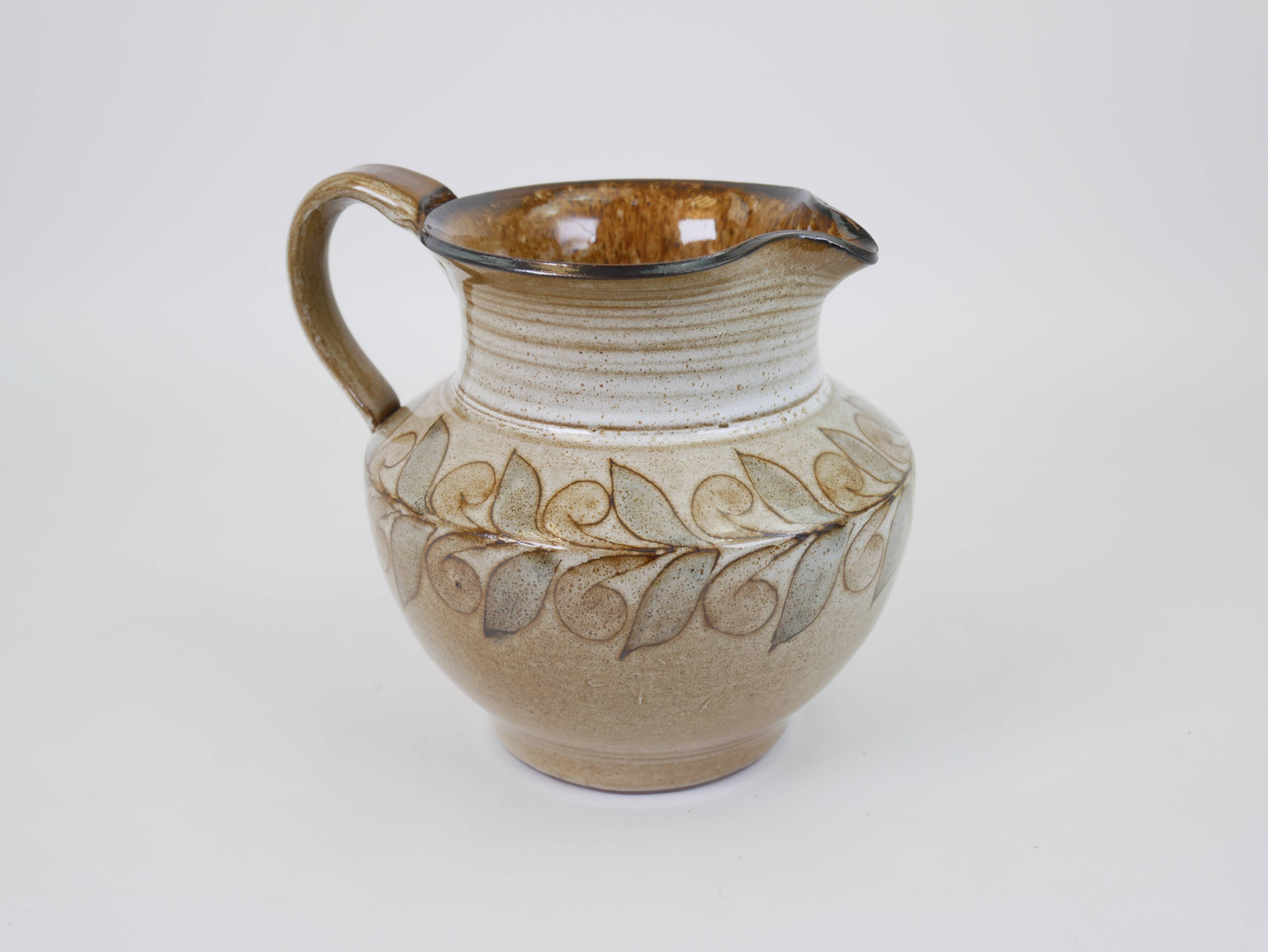 Glazed ceramic jug with plant decoration