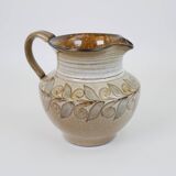 Glazed ceramic jug with plant decoration