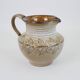 Glazed ceramic jug with plant decoration