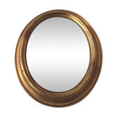 Old oval mirror in gilded wood