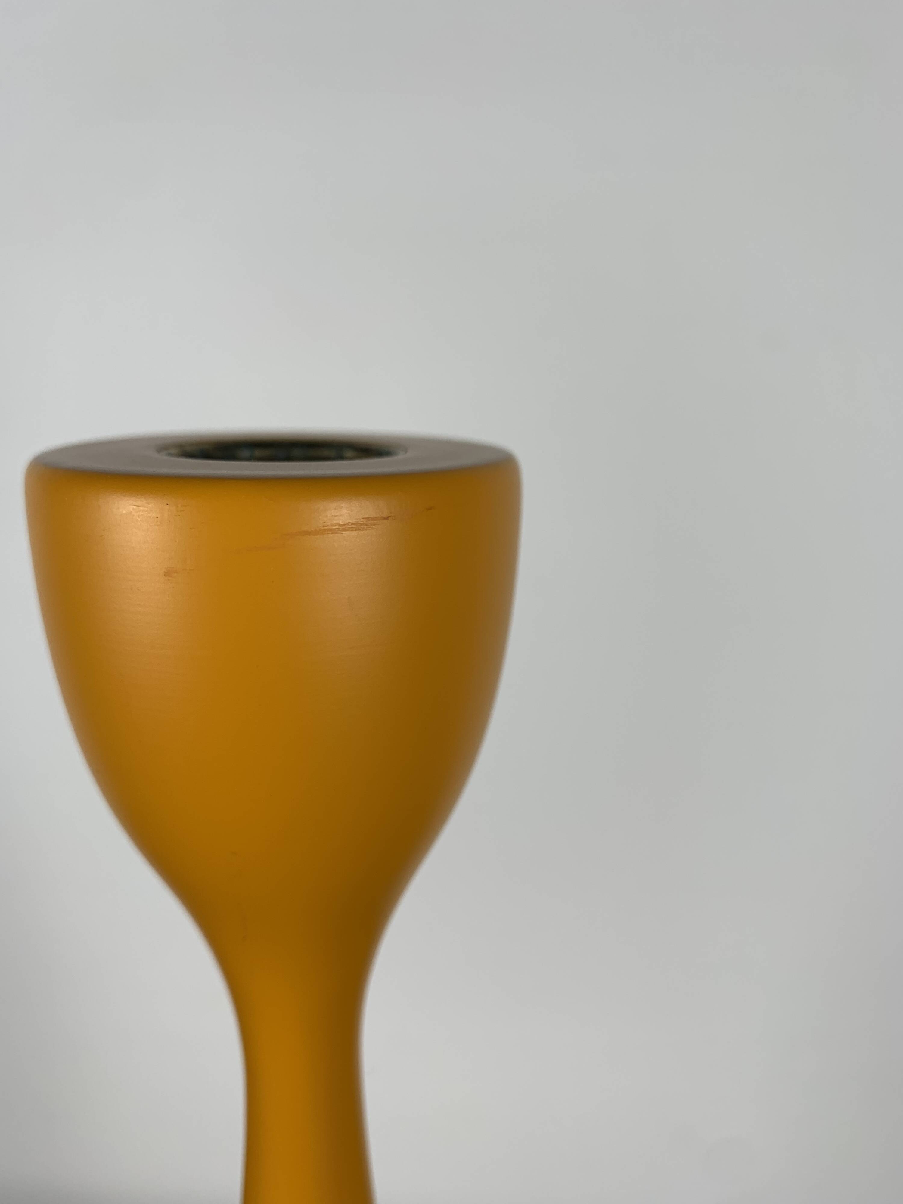 Large candle holder in orange-yellow lacquered wood
