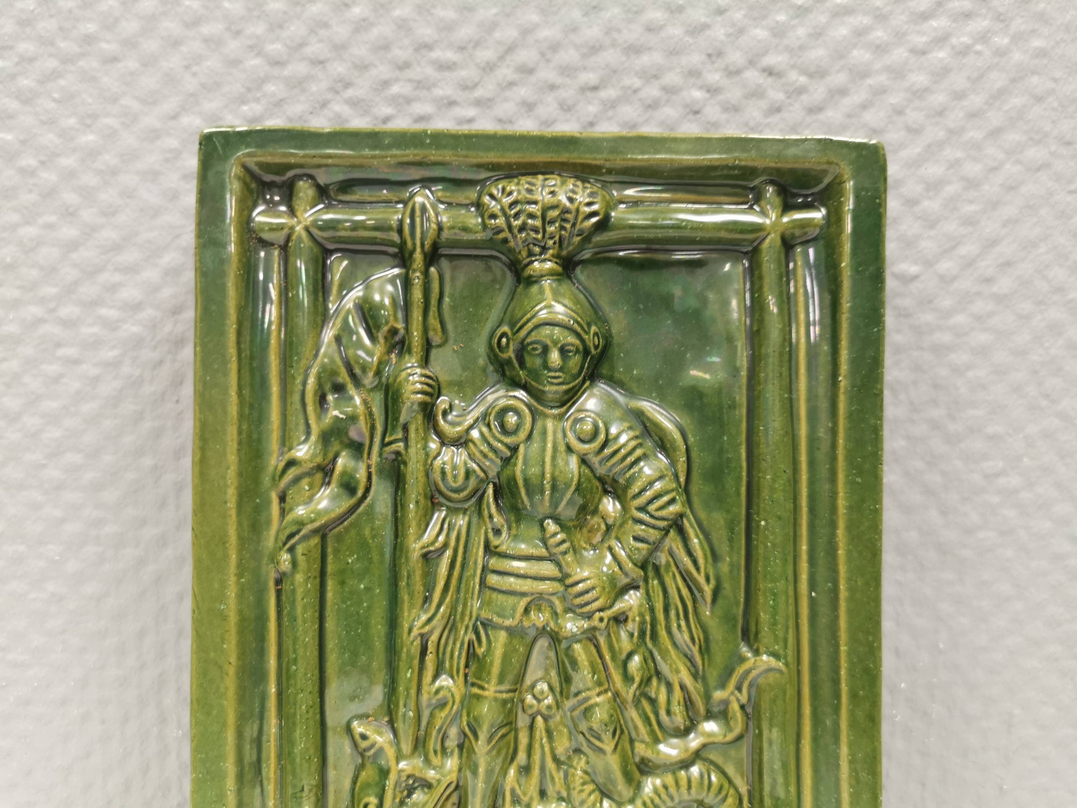 Antique tile in green faience, motif of Saint George and the dragon