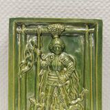 Antique tile in green faience, motif of Saint George and the dragon