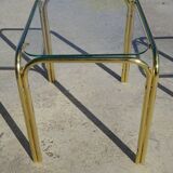 Nested tubular tables in gold metal.