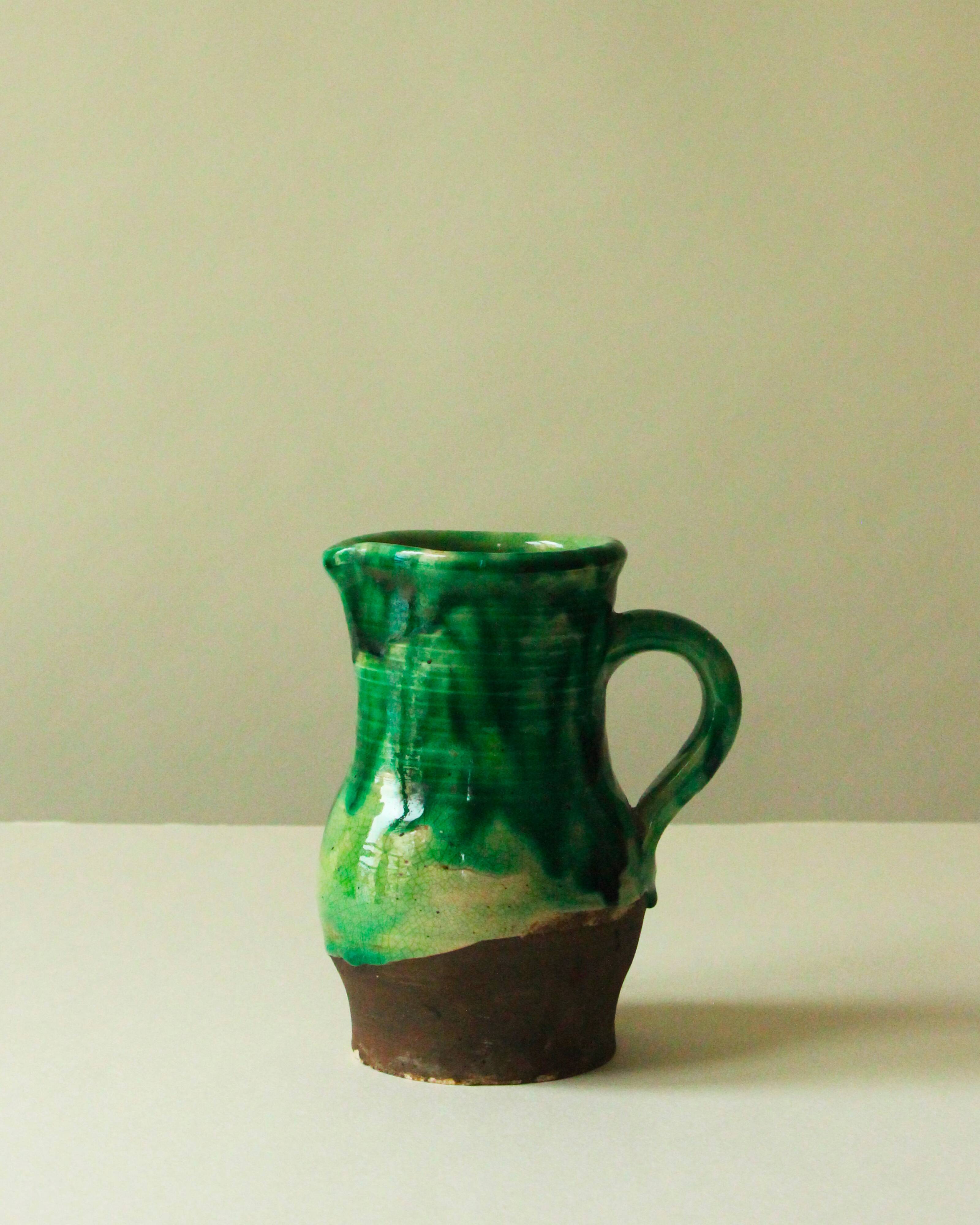 Glazed ceramic pitcher in green and brown by the potter Pierre Roulot.