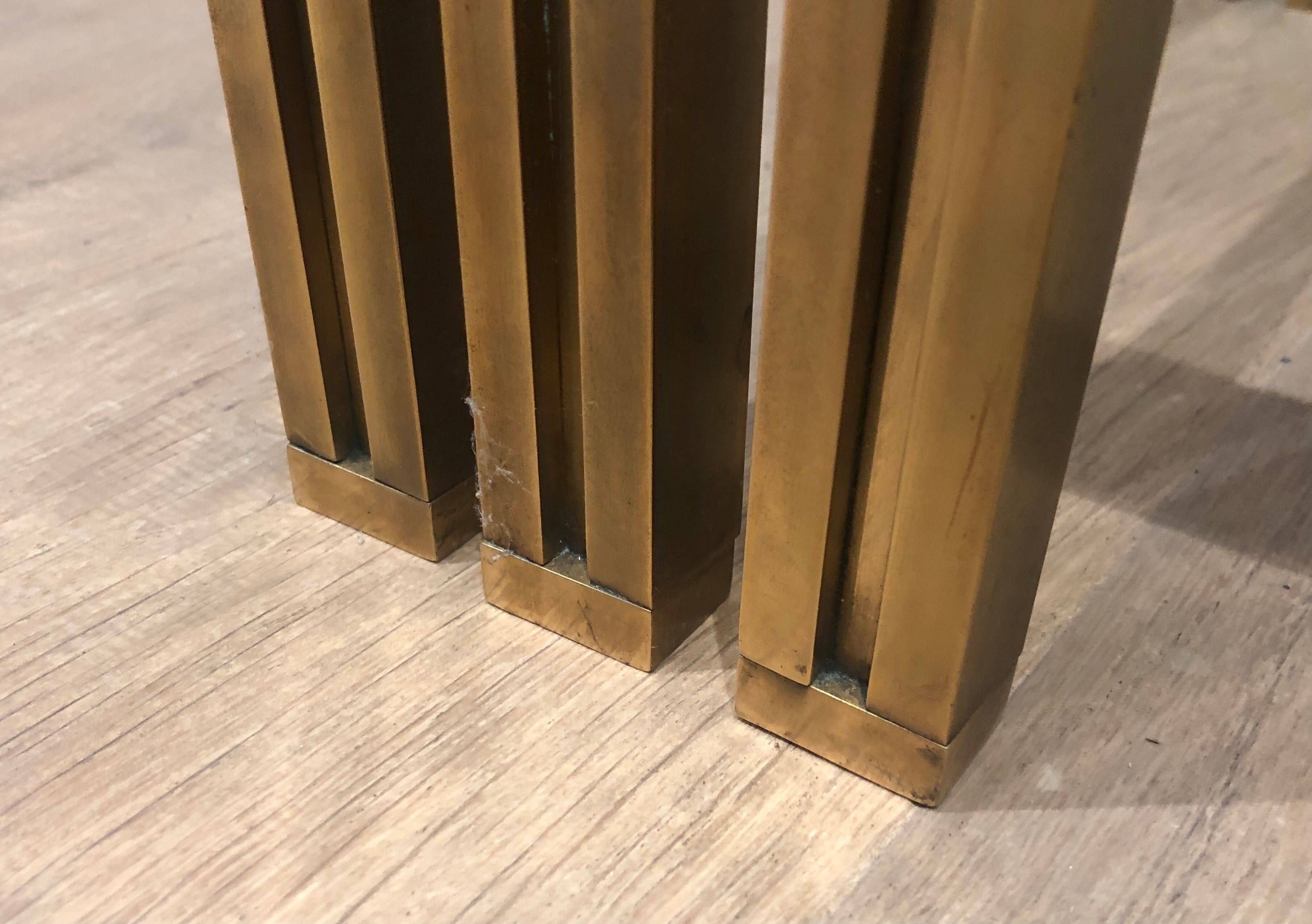 Set of 3 nesting tables in brass and glass. French work by Guy Lef.