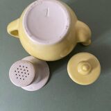 Small lemon yellow porcelain teapot with filter