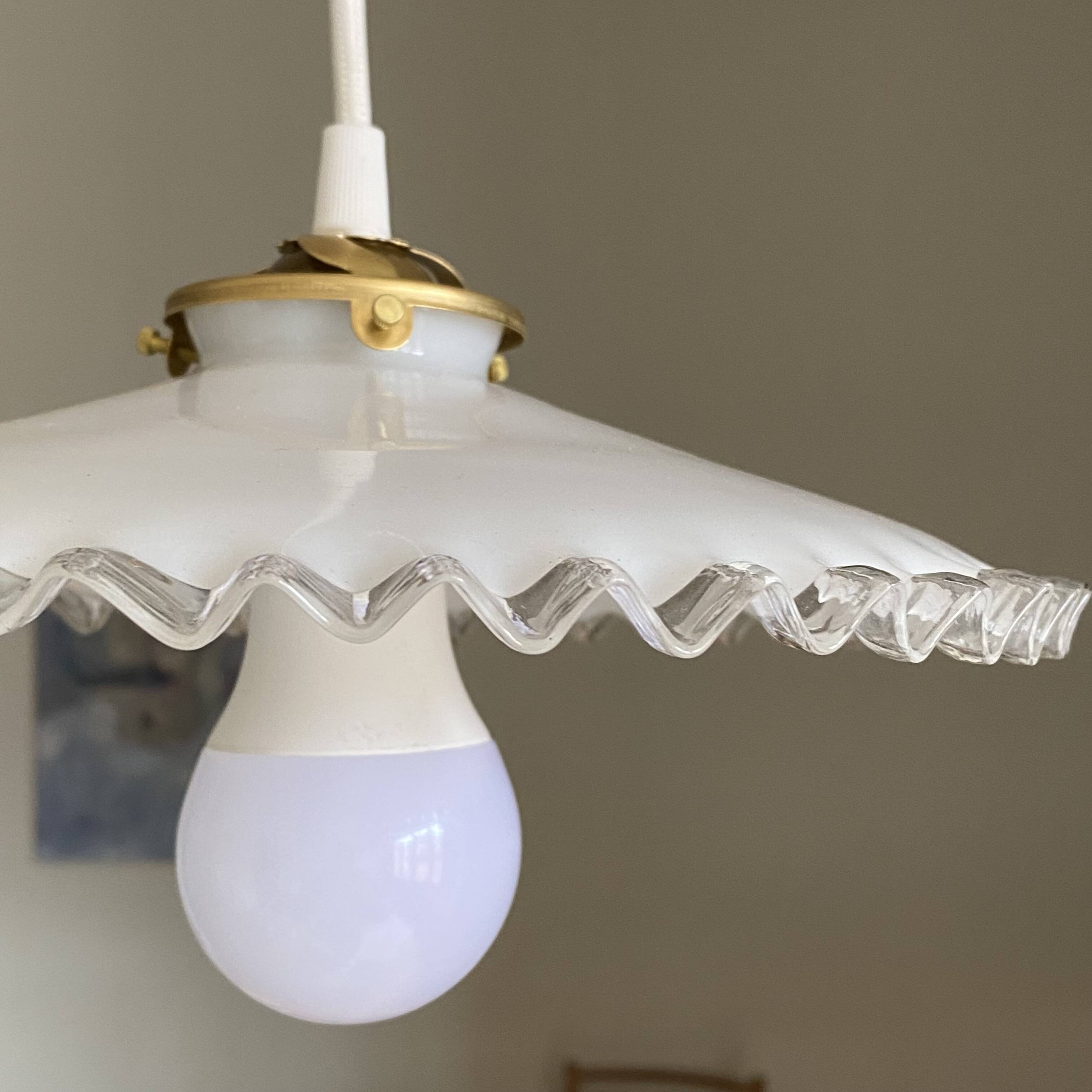 Old lampshade in white opaline glass with a wavy edge.