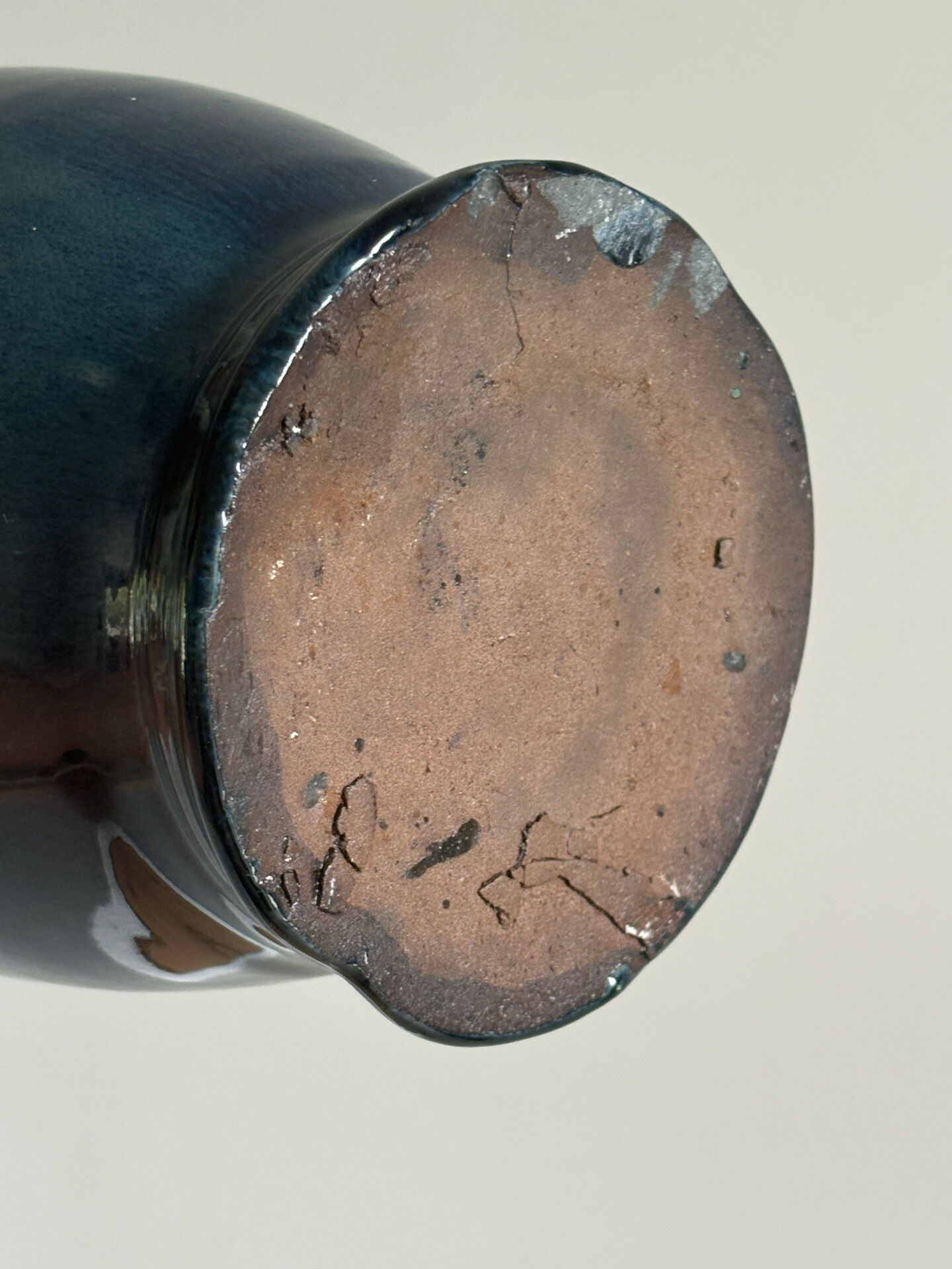 Decorative deep blue glazed ceramic vase with twin handles.