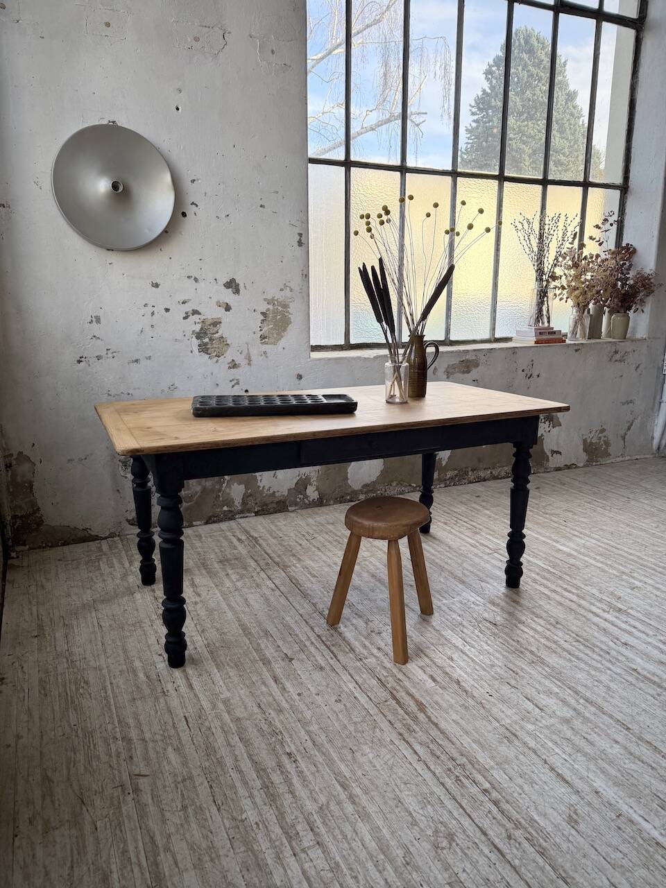Oak farmhouse table with turned black legs.